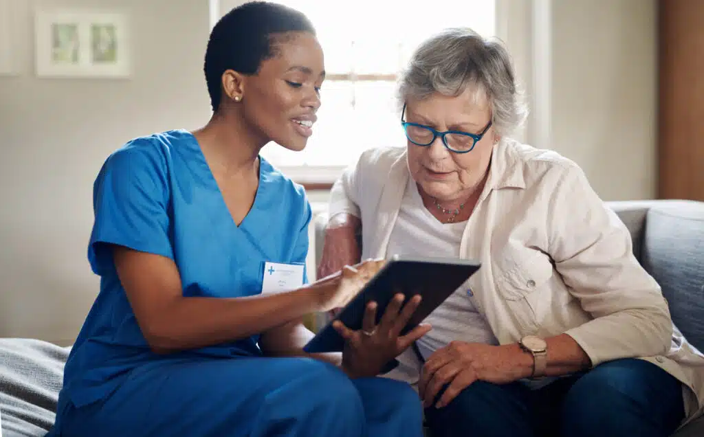 Nurse and patient look at ipad together